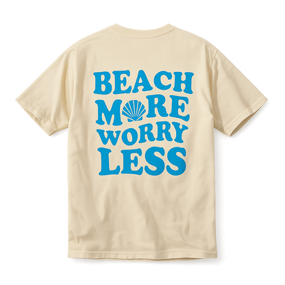 Yellow short sleeve t-shirt with blue text reading ‘Beach More Worry Less’ and a seashell graphic on the back.