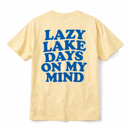 Yellow short sleeve t-shirt with bold blue text reading ‘Lazy Lake Days on My Mind’ on the back.